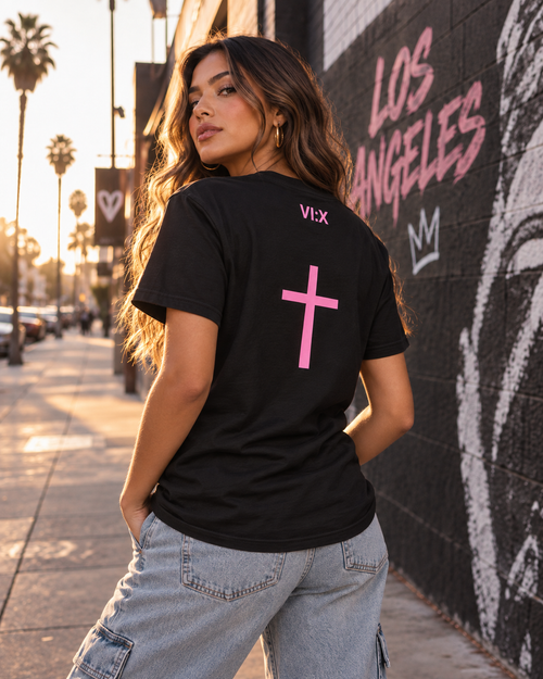 Female model wearing the Armor of God Cross-Back Jersey T-Shirt in black with pink back cross in Los Angeles