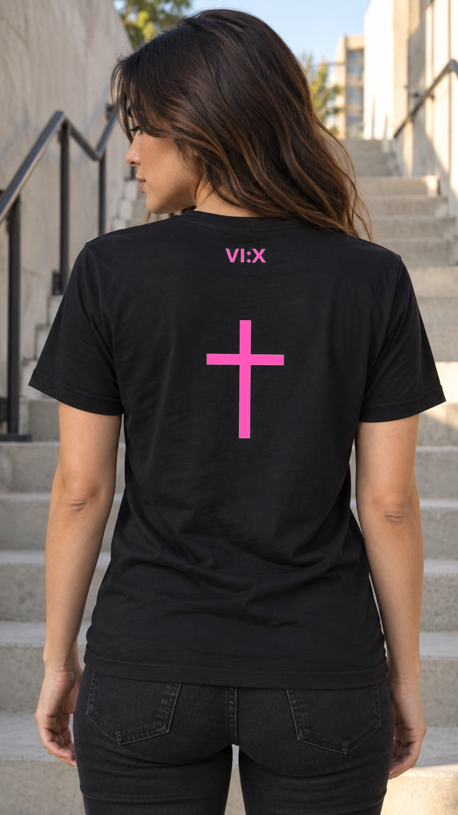 Female model wearing the Armor of God Cross-Back Jersey T-Shirt in black with pink VI:X cross back print in Los Angeles