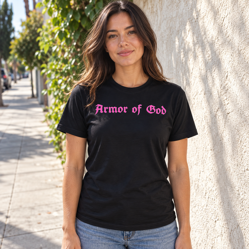 Female model wearing the Armor of God Cross-Back Jersey T-Shirt in black with pink front wordmark in Los Angeles