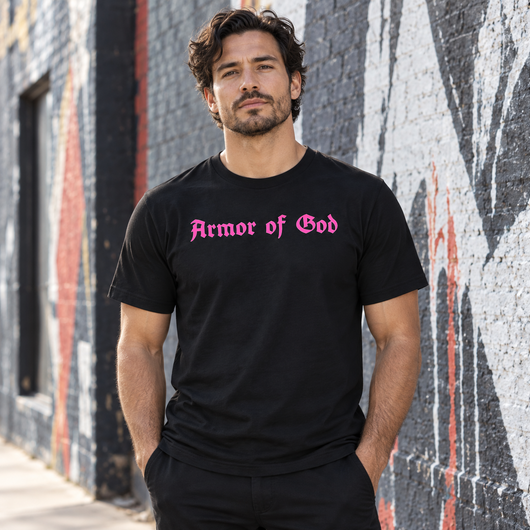 Male model wearing the Armor of God Cross-Back Jersey T-Shirt in black with fully pink front wordmark in Los Angeles