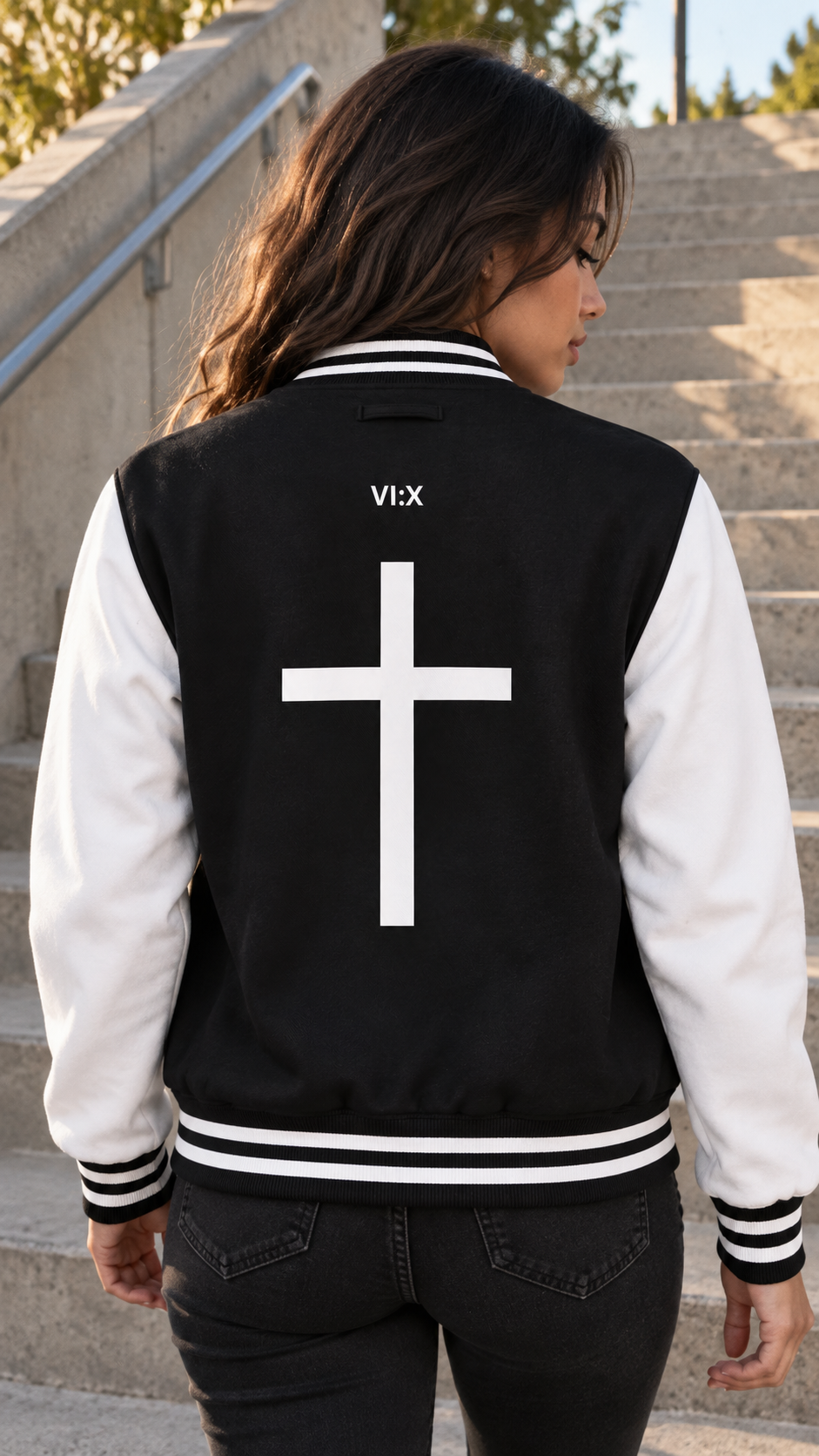 Armor of God Letterman Jacket, female model wearing the back with cross graphic in Los Angeles