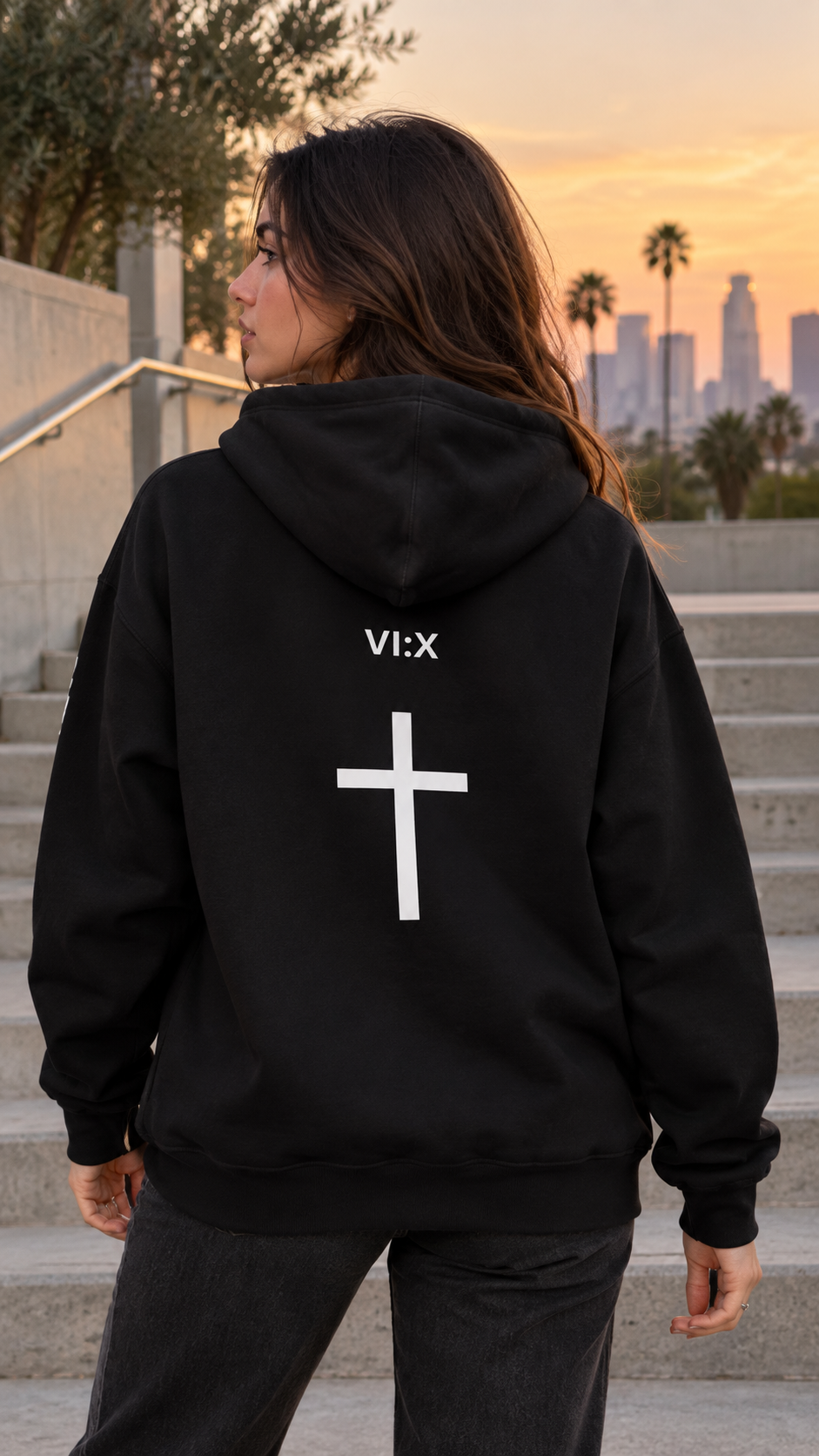 Armor of God Pullover Hoodie, female model wearing the back with VI X cross graphic in Los Angeles