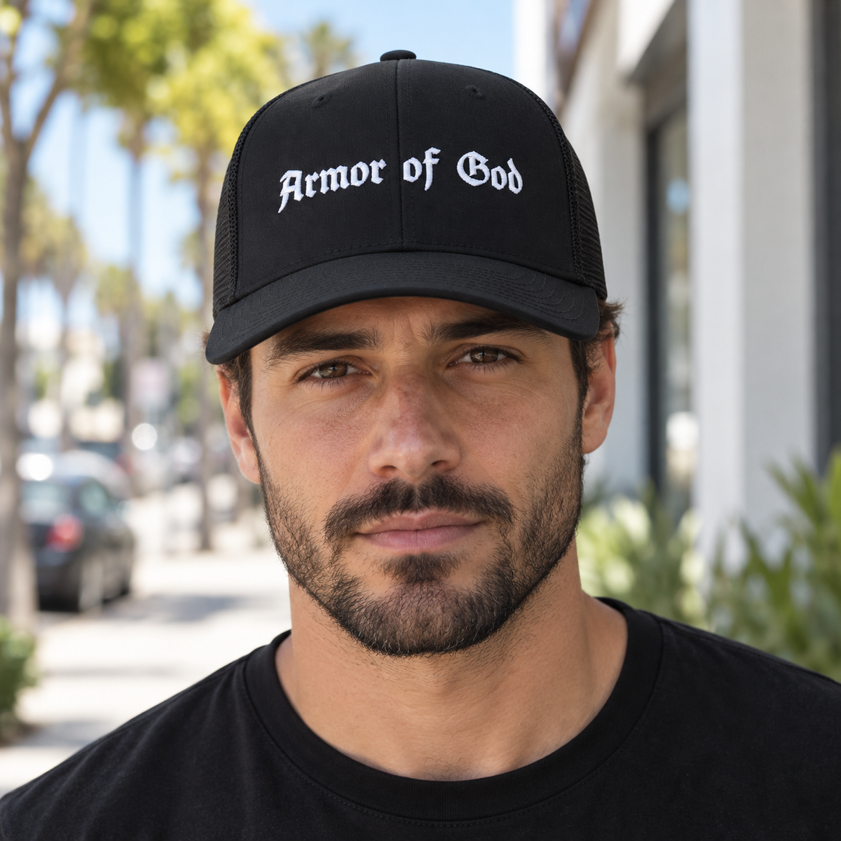 Armor of God Trucker Cap, male model wearing the embroidered front in Los Angeles