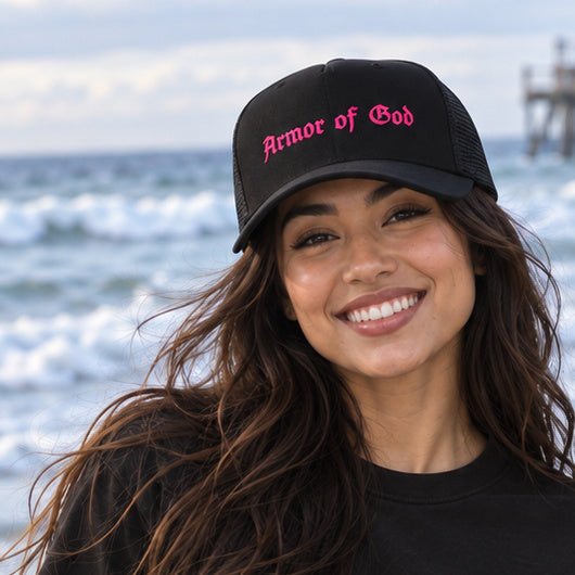 Front lifestyle view of the Armor of God Trucker Cap in Pink